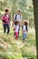 Family Group Hiking In Woods Together