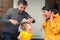 Family haircut at home during quarantine, domestic hairdressers. Mother entertains son while father cuts his child hair. Beauty