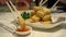Family hands chopsticks eating fried tofu with salt and pepper vegan healthy food Hong Kong Chinese cuisine