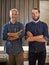 Family, happy portrait and arms crossed of father and son woodwork team with a smile. Entrepreneur, male generation and