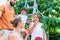 Family harvesting cherries in garden