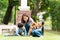 The family has a mother, daughter, and son training for Shiba Inu dogs in the garden