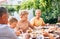 Family have a dinner on open air in summer garden