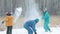 Family have fun during the snowball fight in the forest