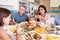 Family Having Argument Sitting Around Table Eating Meal