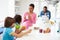 Family Having Breakfast In Kitchen Together