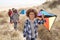 Family Having Fun With Kite In Sand Dunes