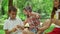 Family having fun in park together. Happy siblings playing with soap bubbles