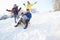 Family Having Fun Sledging Down Snowy Hill