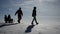 Family having fun in the snow with a sledge