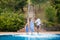 Family having fun their pool. family splashing water with legs or hands in swimming pool