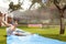 Family Having Fun On Water Slide In Garden