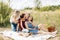 The family is having a picnic on the lawn. Three generations of women of the same family rest together