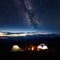 Family hikers having a rest at night camping in mountains