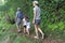 Family hiking the Cross Island Track in the rain forest of a tropical pacific island