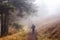 Family hiking through a misty forest