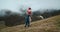 Family hiking together woman holding daughter an climbs mountain