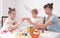 Family holiday Easter: Mom and daughter are knocking Easter eggs.