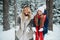 In a family holiday home in the forest, a lovely mother and daughter are resting in winter, enjoying the first snow