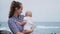 Family holiday on Tenerife, Spain, Europe. Mother and baby outdoors on ocean. Portrait travel tourists - mom with child