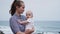 Family holiday on Tenerife, Spain, Europe. Mother and baby outdoors on ocean. Portrait travel tourists - mom with child