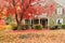 Family house with front lawn in fall colors