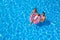 Family with inflatable ring in swimming pool, space for text. Summer vacation