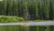 Family in a Kayak on a Lake near the Forest