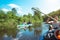 Family kayak trip. Father and daughter, and elderly couple senior and seniora rowing boat on the river, a water hike, a summer