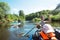 Family kayak trip. Father and daughter, and elderly couple senior and seniora rowing boat on the river, a water hike, a summer