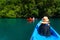 Family kayaking in mangroves