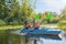 Family kayaking, mother and child paddling in kayak on river canoe tour, active autumn weekend and vacation, sport and fitness