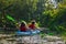 Family kayaking, mother and child paddling in kayak on river canoe tour, active autumn weekend and vacation, sport and fitness