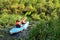 Family kayaking, mother and child paddling in kayak on river canoe tour having fun, active weekend and vacation, fitness co