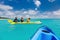 Family kayaking at tropical ocean