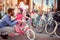 Family with kid having fun outdoor shopping new bicycle and helmets