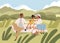 Family with kid on summer picnic. Happy biracial parents and child relaxing on blanket on grass in nature. Mother