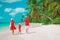 Family with kid walk on beach, enjoy tropical vacation