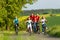 Family with kids cycling in summer with bicycles