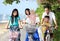 Family with kids enjoy riding bicycle outdoor in the beach