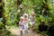 Family with kids hiking in jungle.