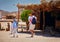 Family with kids, tourists walking through bedouin village in Sahara desert during safari tour