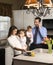 Family in kitchen.