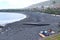 A family on La Caleta beach with black volcanic sand in the Atlantic ocean, perfect for relaxing. Caleta de Interian, Tenerife, S