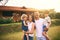 Family, laugh and new home with father, mother and kids with happiness and love. Outdoor, bonding and lens flare of a