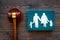 Family law, family right concept. Child-custody concept. Family with children cutout near court gavel on dark wooden