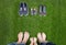 Family legs in jeans and shoes standing on grass