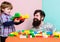 Family leisure. Father son game. Father and son create constructions. Bearded man and son play together. Every dad and