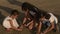 Family, leisure and people concept-three asian sisters playing with sand on the beach