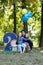 Family life. Portrait of father and his children in the Park. Birthday of a two year old boy. Decor with the number two with lion